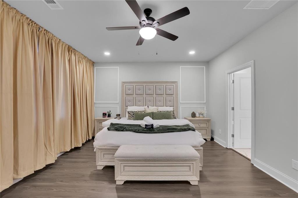 8026 Linfield Way Sandy Springs, GA 30350 - Photo 3 of 12 a bedroom with a bed and a large window