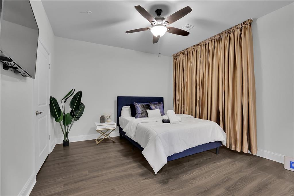 8026 Linfield Way Sandy Springs, GA 30350 - Photo 7 of 12 a bedroom with a bed and a chandelier