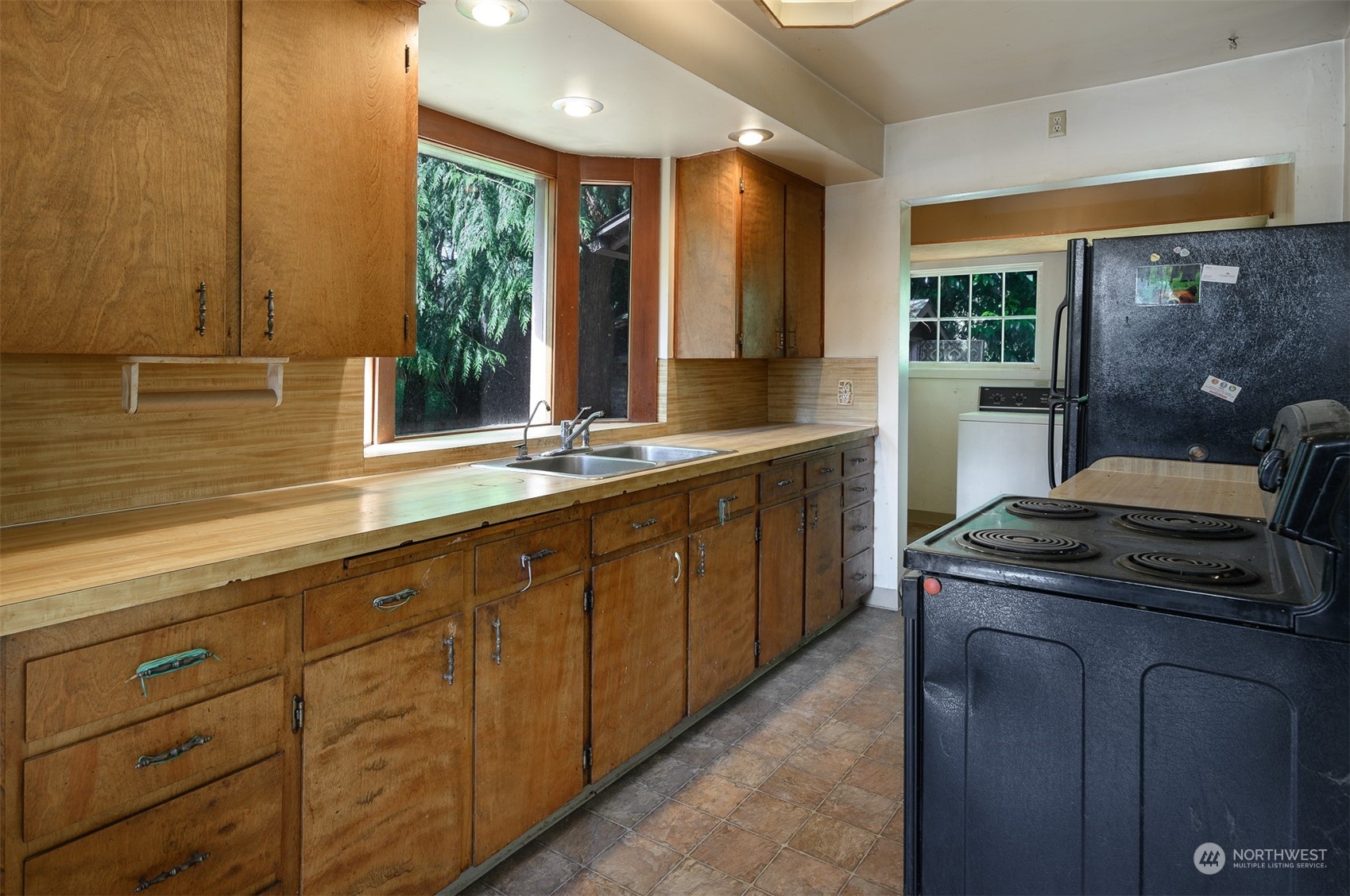 209 Southwest 132nd Street Burien, WA 98146 - Photo 17 of 27 a kitchen with stainless steel appliances granite countertop a stove and a sink