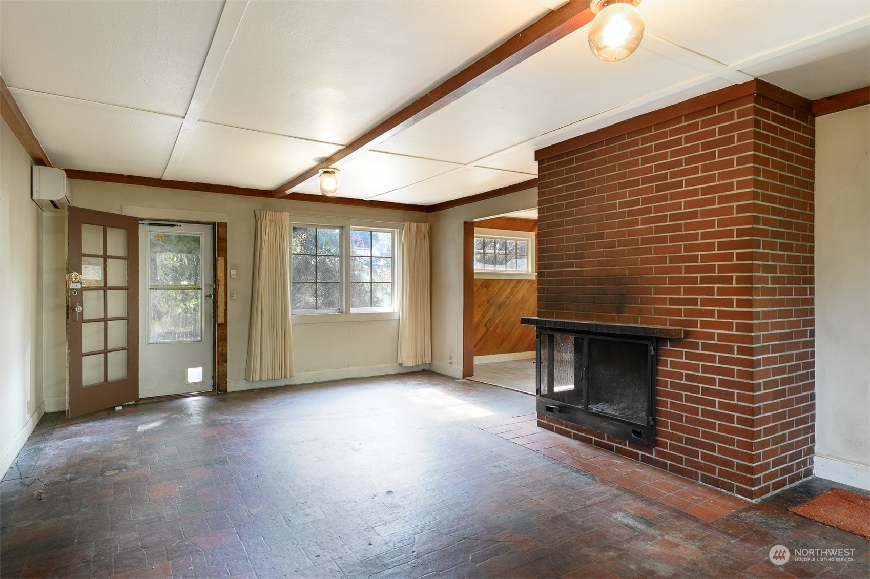 209 Southwest 132nd Street Burien, WA 98146 - Photo 9 of 27 a view of an empty room with a fireplace and a window