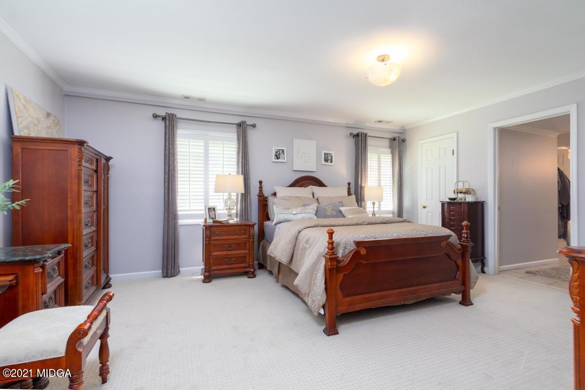993 Lee King Road Forsyth, GA 31029 - Photo 14 of 32 a bedroom with a bed flat screen tv and dresser