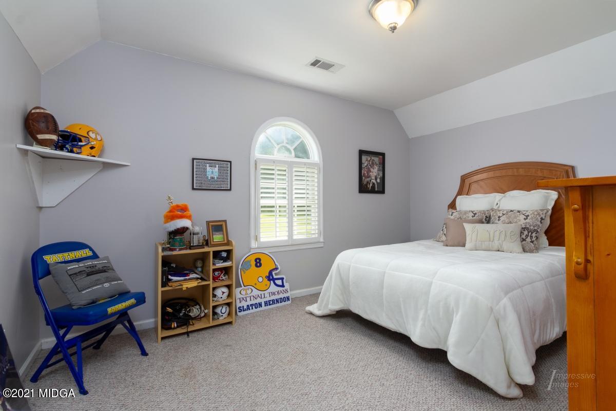 993 Lee King Road Forsyth, GA 31029 - Photo 22 of 32 a bedroom with bed and a window