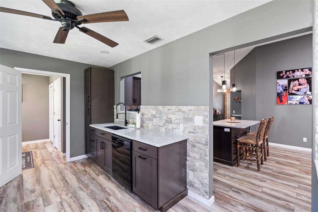 11311 Northeast 40th Street Road Silver Springs, FL 34488 - Photo 22 of 67 a kitchen with a table chairs refrigerator and cabinets