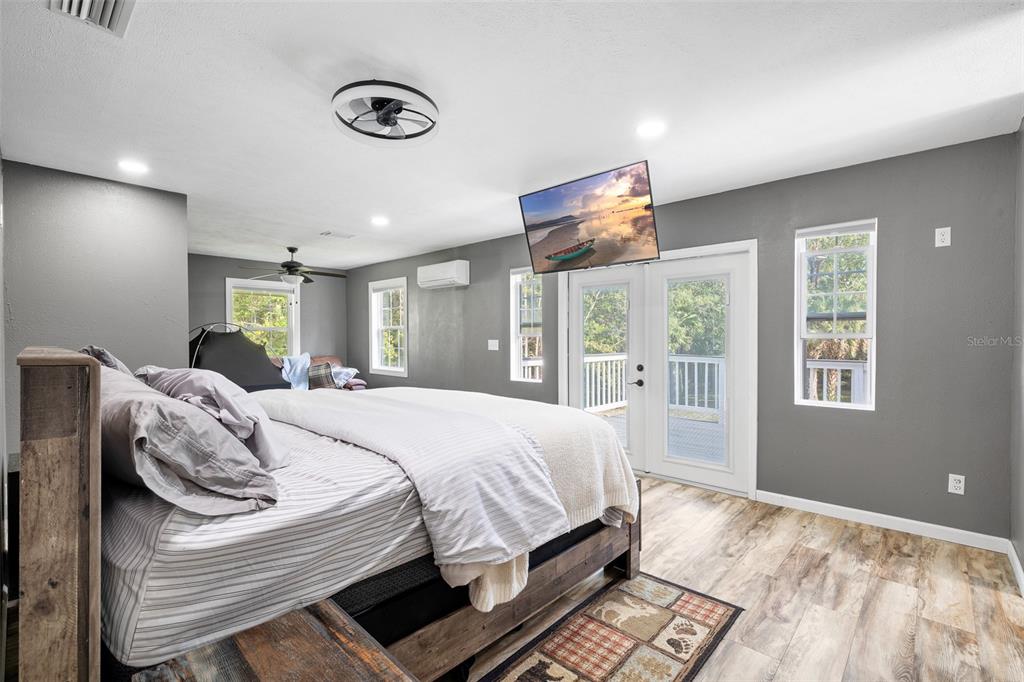 11311 Northeast 40th Street Road Silver Springs, FL 34488 - Photo 24 of 67 a bed sitting in a bedroom next to a window