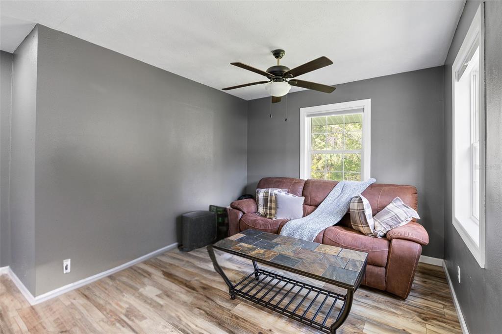 11311 Northeast 40th Street Road Silver Springs, FL 34488 - Photo 27 of 67 a living room with furniture and a window