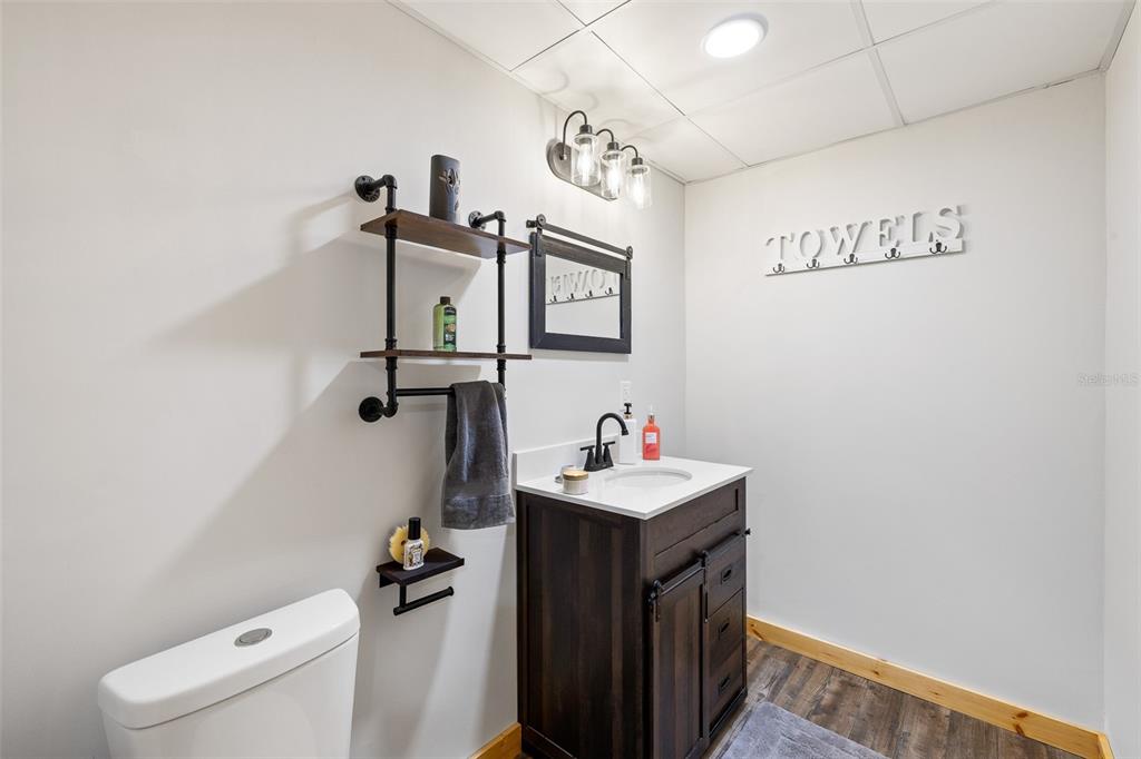 11311 Northeast 40th Street Road Silver Springs, FL 34488 - Photo 42 of 67 a bathroom with a sink a toilet and a mirror