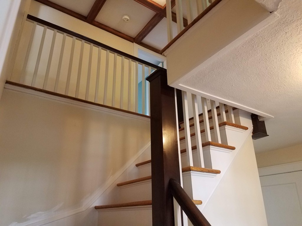 80 Eleanor Road Springfield, MA 01108 - Photo 14 of 30 a view of staircase with lots of frames on wall and a window
