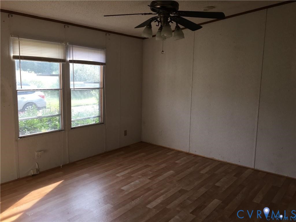 12232 Darbys Road Doswell, VA 23047 - Photo 12 of 17 Primary bedroom room with ceiling fan, wood finish