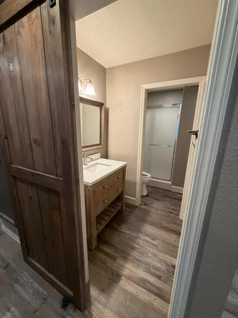 a view of bedroom with a bed and wooden floor