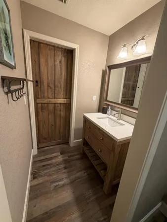 a bathroom with a sink a mirror and shower