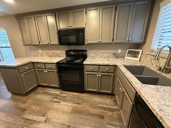 a view of a refrigerator in kitchen and wooden floor