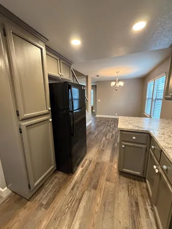 a kitchen with stainless steel appliances granite countertop a sink and a stove