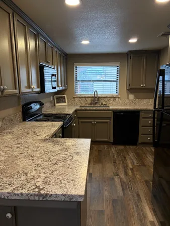 a kitchen with granite countertop stainless steel appliances and cabinets