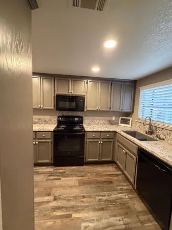 a bathroom with a granite countertop sink and window