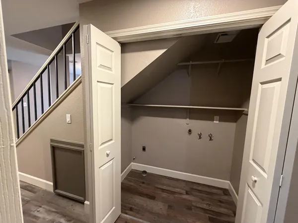 a spacious bedroom with a bed and a mirror