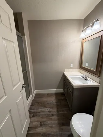 a view of entryway and hall with wooden floor