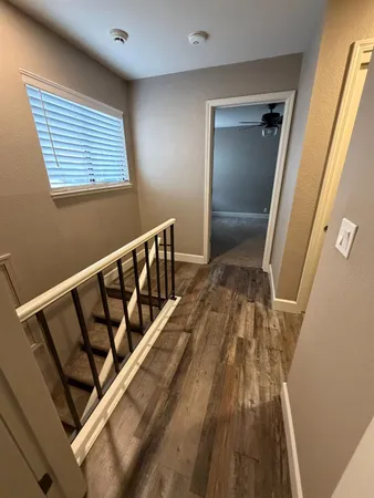 a view of a white house with a big yard and large tree