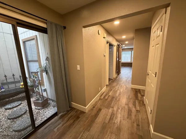 a view of hallway with wooden floor