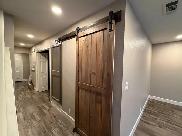 a bathroom with a glass shower door and a sink