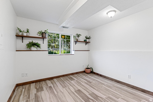 814 Mountain Road Logan, UT 84321 - Photo 28 of 42 Room featuring wood-finish tile flooring, white painted walls, and wood trim