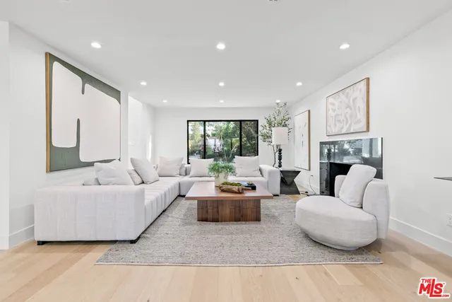 a dining room with furniture and large windows