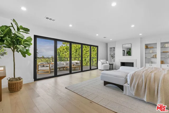 a view of cabinets a wooden floor and potted plant