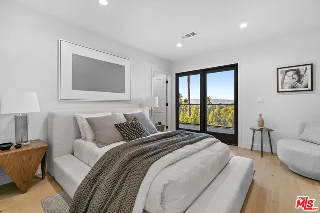 a view of a hallway with wooden floor and windows