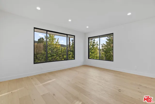 a view of a swimming pool with a bench and some trees