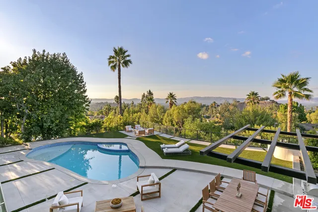 swimming pool view with a seating space