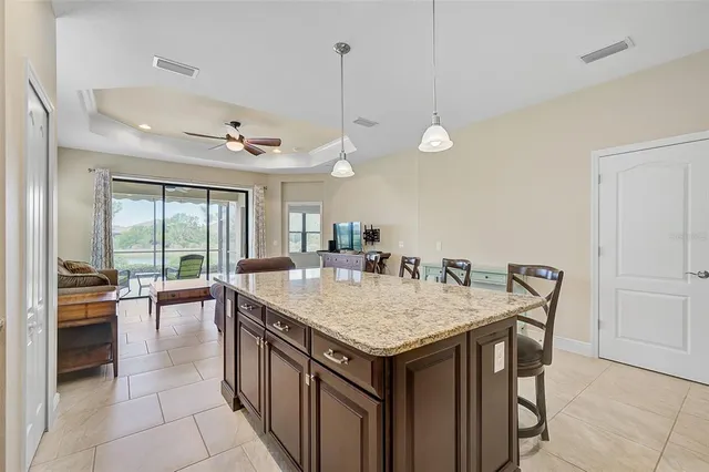 a living room with furniture and kitchen view