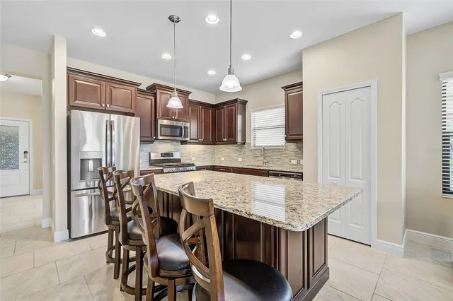 a living room with furniture and a large window with balcony view