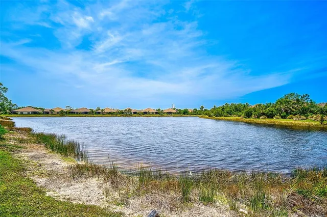 an aerial view of a house with a lake view