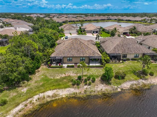 a front view of a house with a yard and potted plants