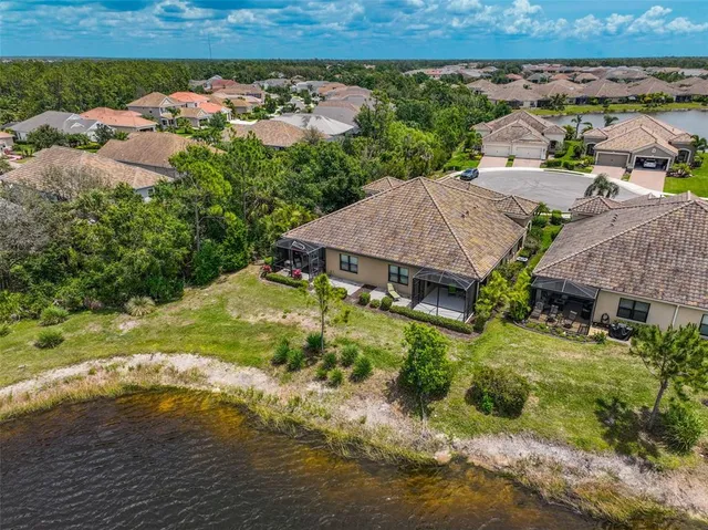 an aerial view of a house with swimming pool garden and patio