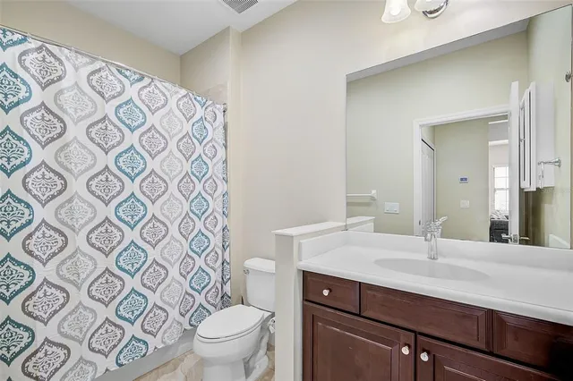 a kitchen with kitchen island granite countertop a stove a sink a microwave a center island and chairs