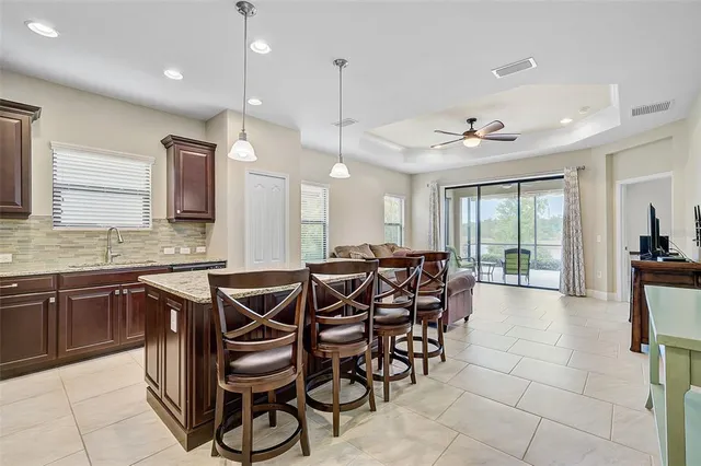 a kitchen with a table chairs refrigerator and microwave