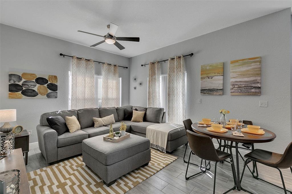 4561 Yellowgold Road East, Unit 102 Kissimmee, FL 34746 - Photo 3 of 12 a living room with furniture and a large window