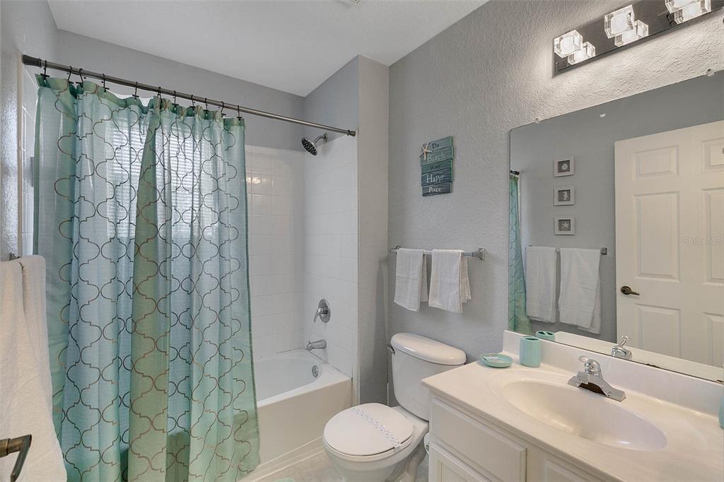 4561 Yellowgold Road East, Unit 102 Kissimmee, FL 34746 - Photo 5 of 12 a bathroom with a sink toilet and shower