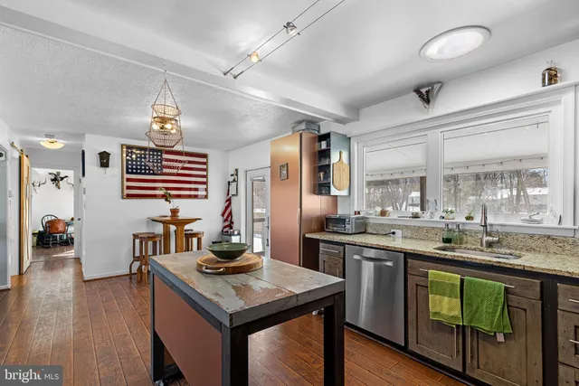a kitchen with lots of counter top space and stainless steel appliances