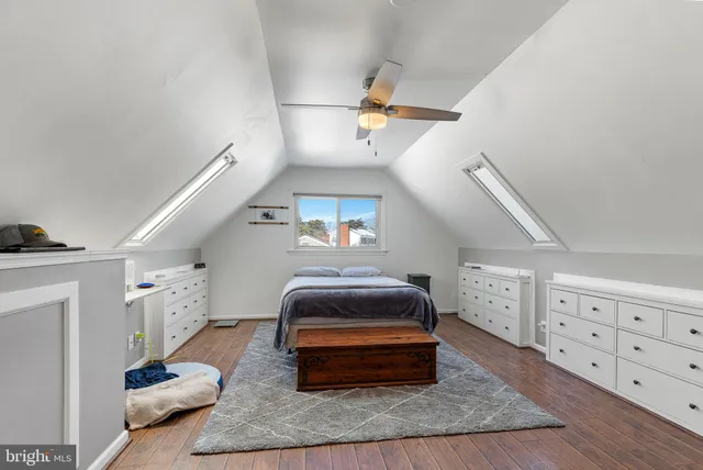 a bedroom with furniture and a wooden floor
