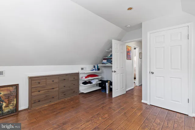 a bedroom with furniture and wooden floor