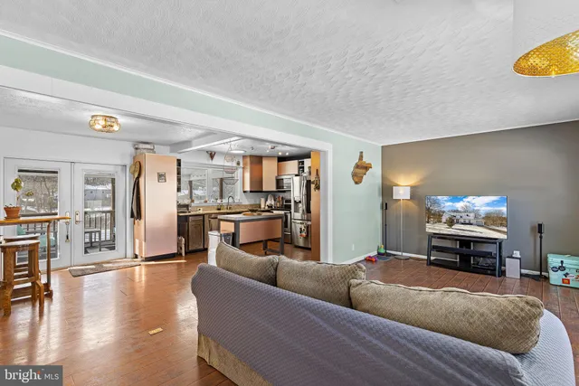 a living room with furniture and a kitchen view