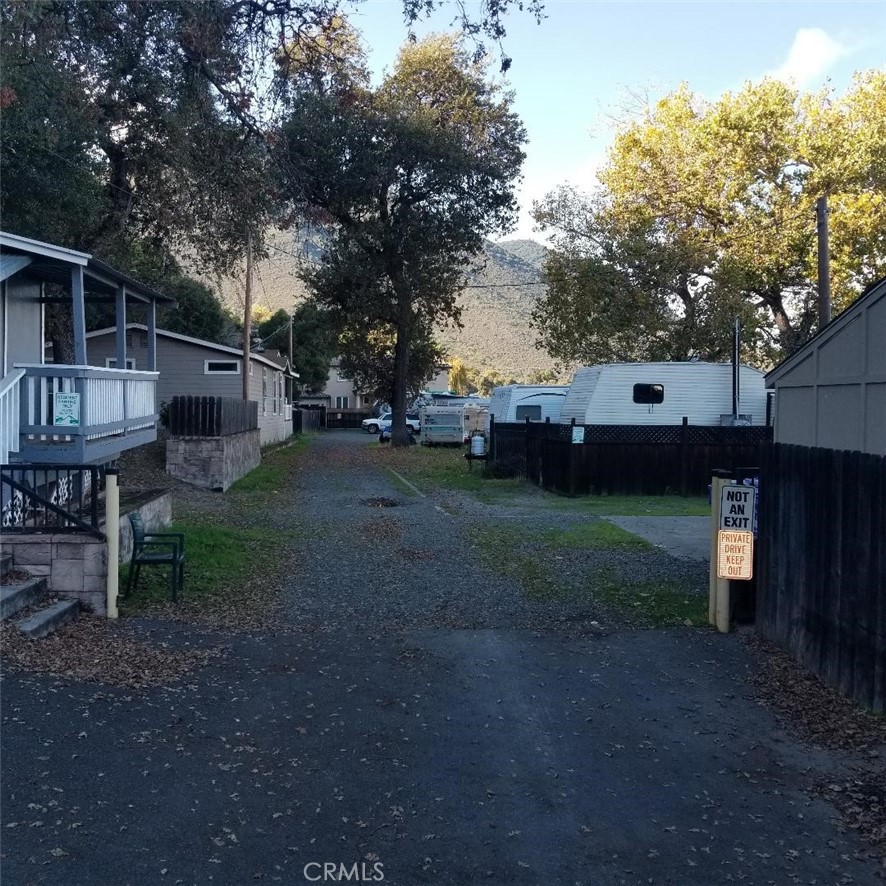 9435 Konocti Bay Road Kelseyville, CA 95451 - Photo 4 of 12 a backyard of a house with wooden fence and large trees