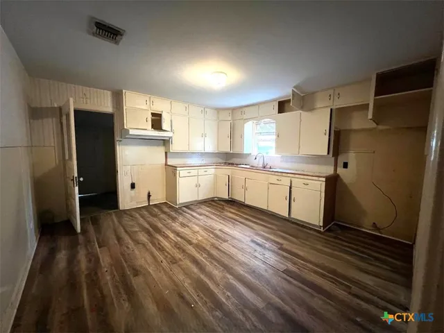 a kitchen with stainless steel appliances a refrigerator and a sink