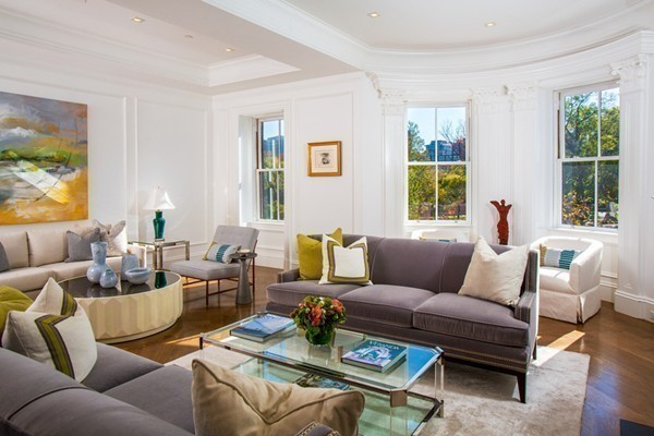 a living room with furniture wooden floor and a window