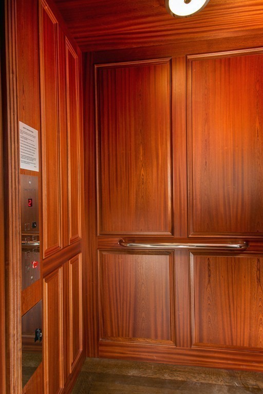 89 Beacon Street, Unit PH Boston, MA 02108 - Photo 15 of 22 an empty room with wooden floor and windows