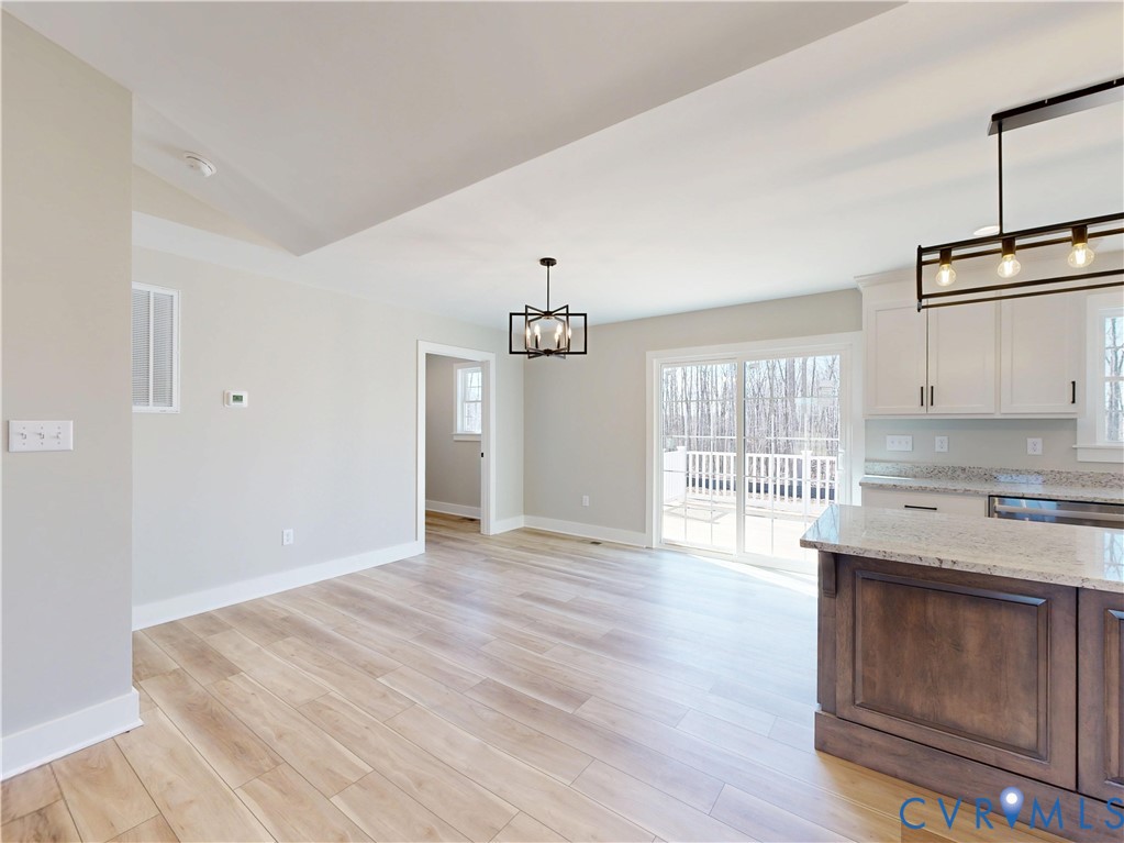 15085 Lebanon Road Spring Grove, VA 23881 - Photo 5 of 16 a kitchen with granite countertop a stove cabinets and wooden floor