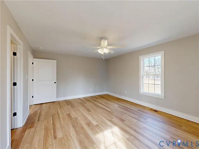 a view of a room with wooden floor and white walls