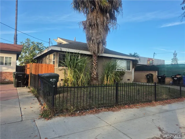 a view of a wrought iron fences in front of house