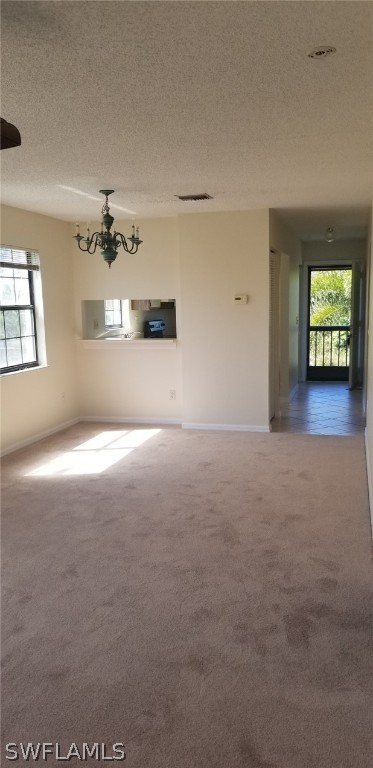 5277 Treetops Drive, Unit W204 Naples, FL 34113 - Photo 13 of 19 en empty room with windows and ceiling fan